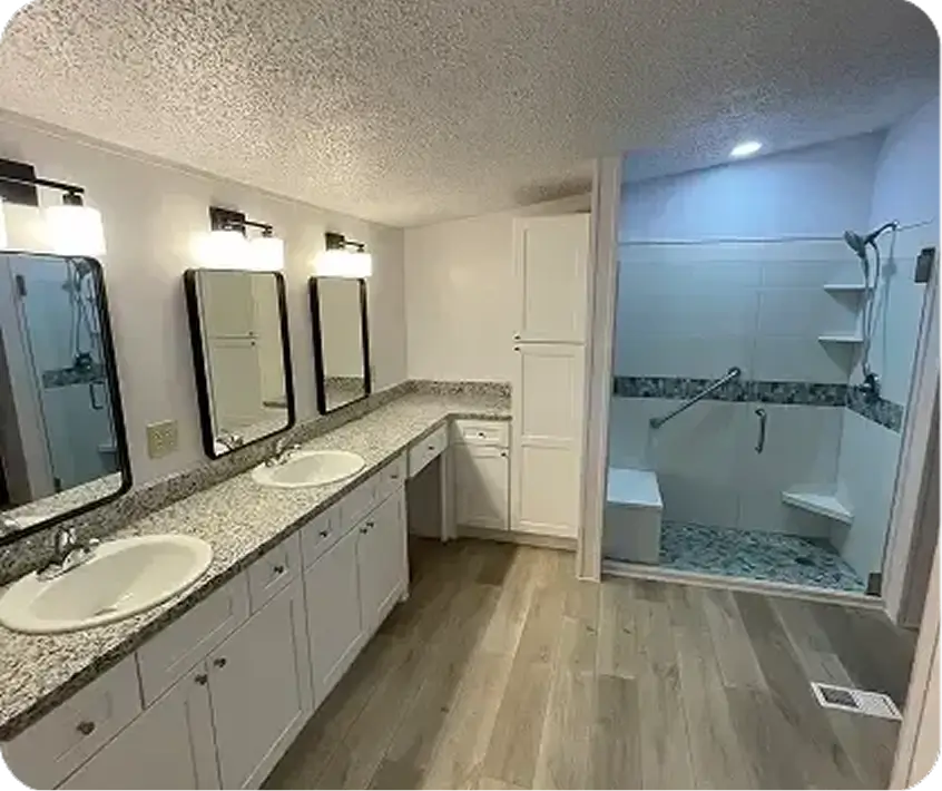 Dual white drop-in sinks set into speckled granite-style countertops
