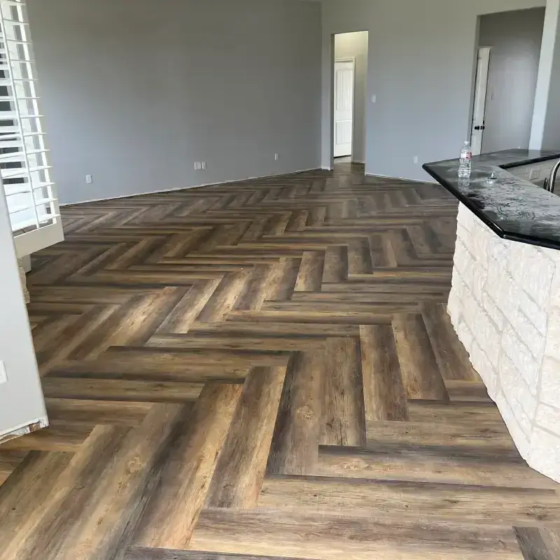 The V-shaped zig-zag herringbone layout adds architectural movement and visual depth to the open living space