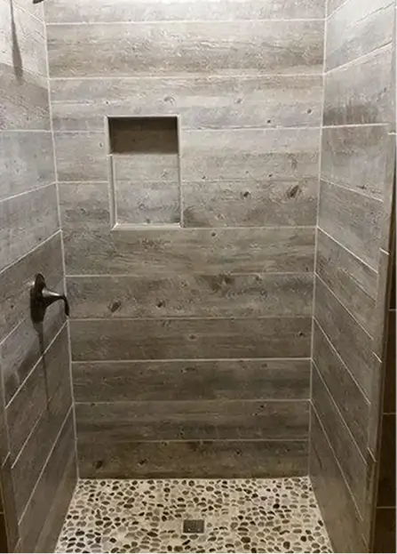 Weathered barnwood-style porcelain or ceramic planks in gray-brown tones
