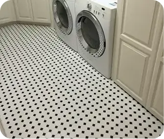 a classic white octagon-and-black-dot porcelain mosaic floor tile pattern installed in a laundry room