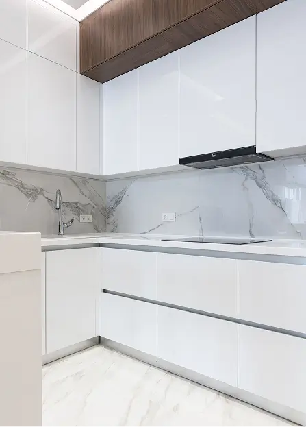 a modern minimalist kitchen design featuring sleek white glossy cabinetry paired with contrasting dark wood