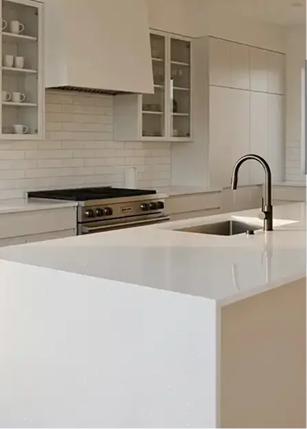 a sleek, modern kitchen island featuring a seamless white quartz waterfall