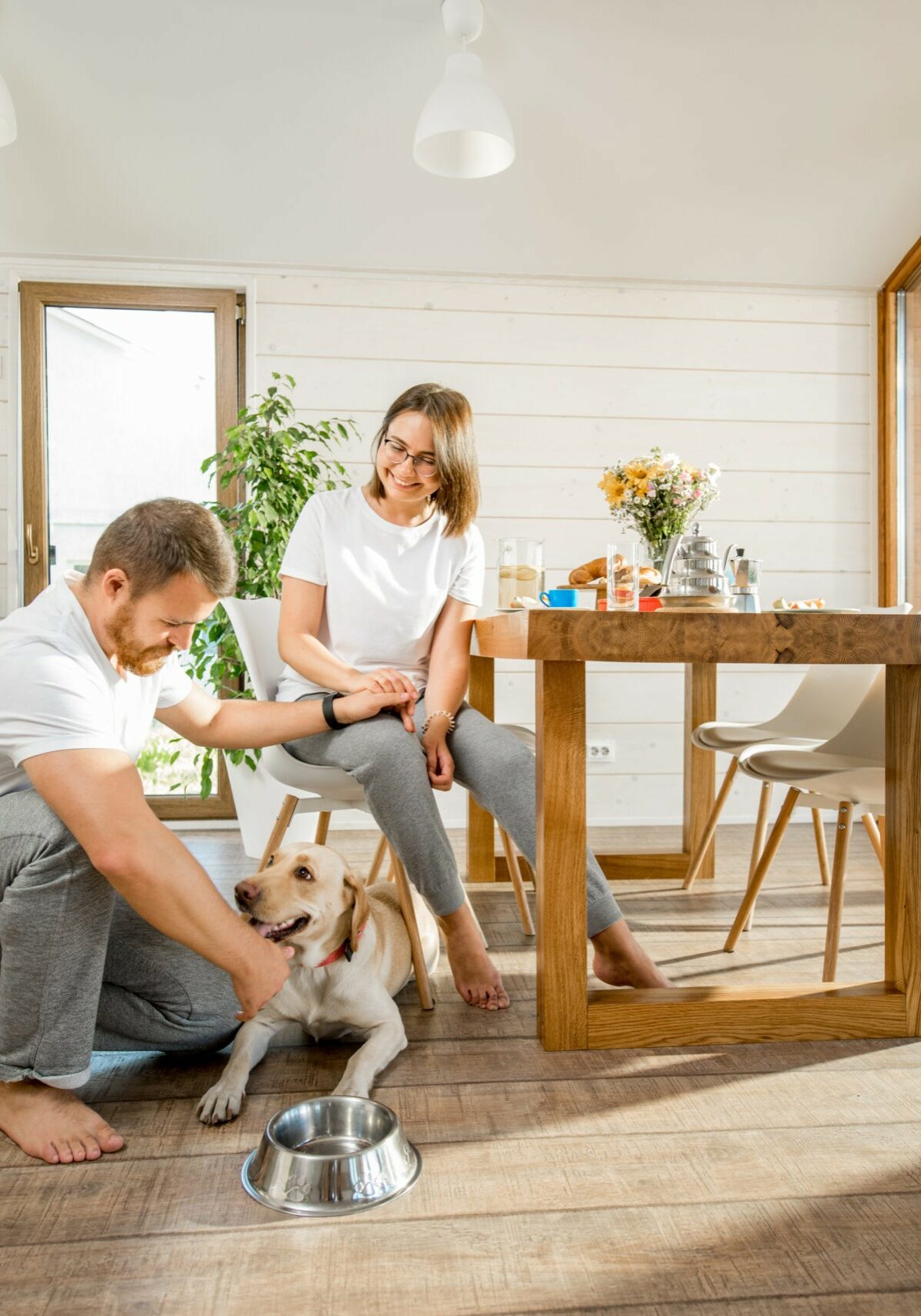 Young couple with dog at home | Raider Flooring