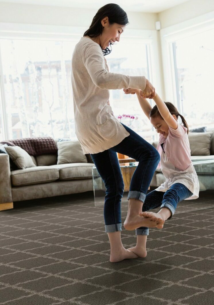 Mom playing with baby on Carpet flooring | Raider Flooring
